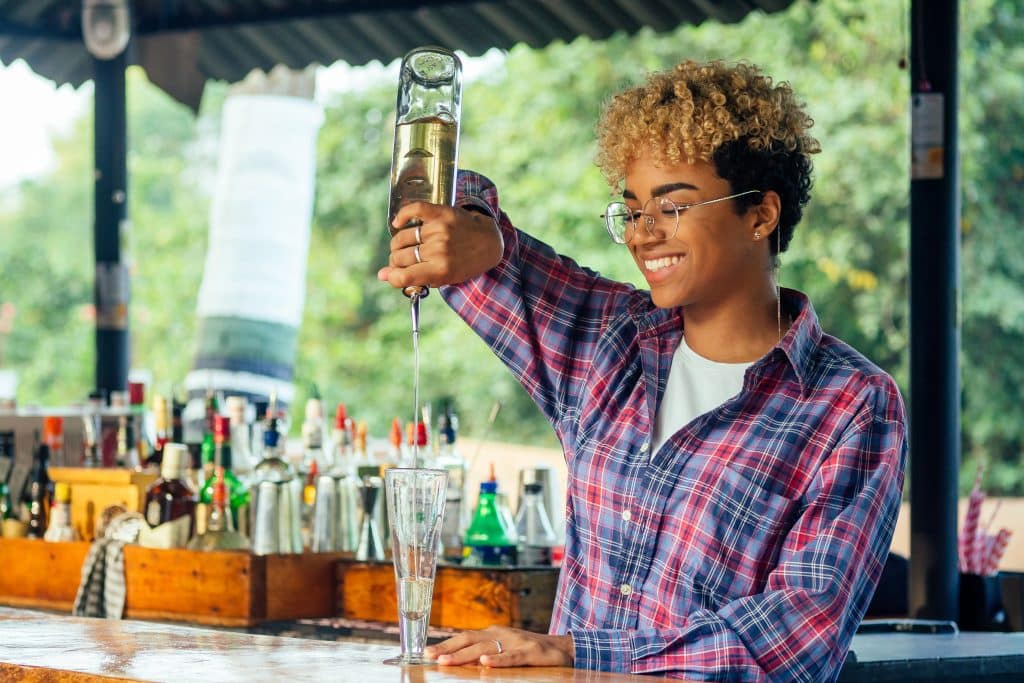 female bartender pouring a drink