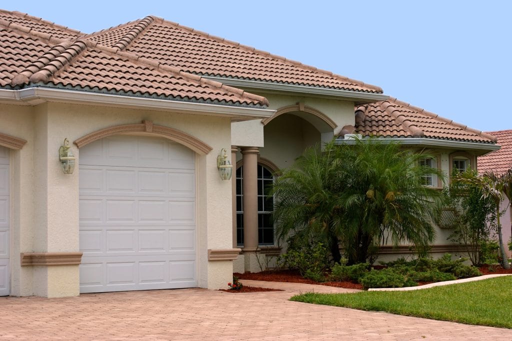 typical Florida home with palm trees and Spanish tile roof