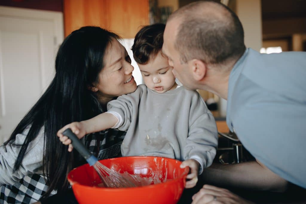 parents baking with young child